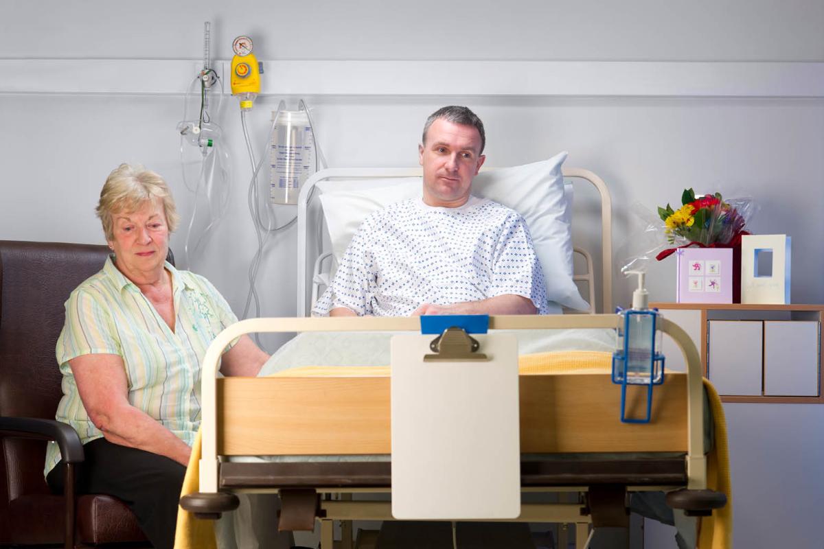 Family members sitting at the bedside of a patient