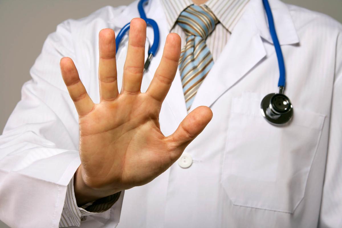 Doctor making "stop" gesture with hand