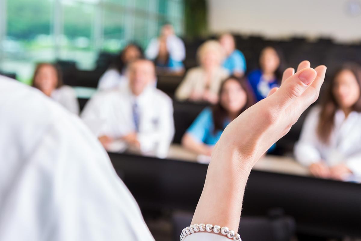 Person speaking in front of an audience