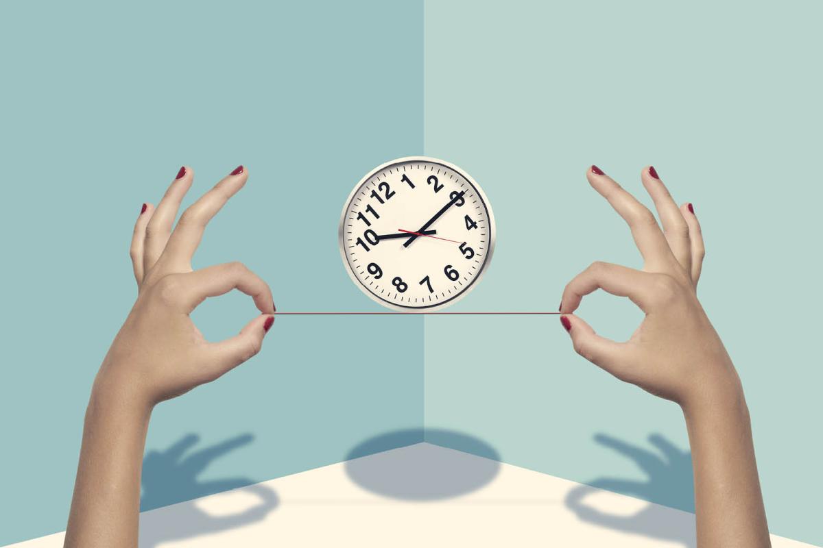 Two hands balancing a clock