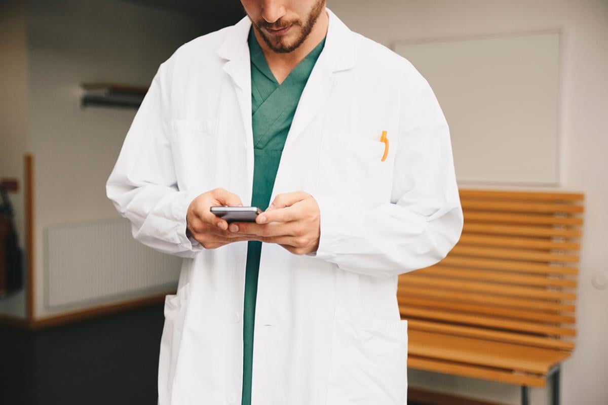 Physician looking at a smartphone