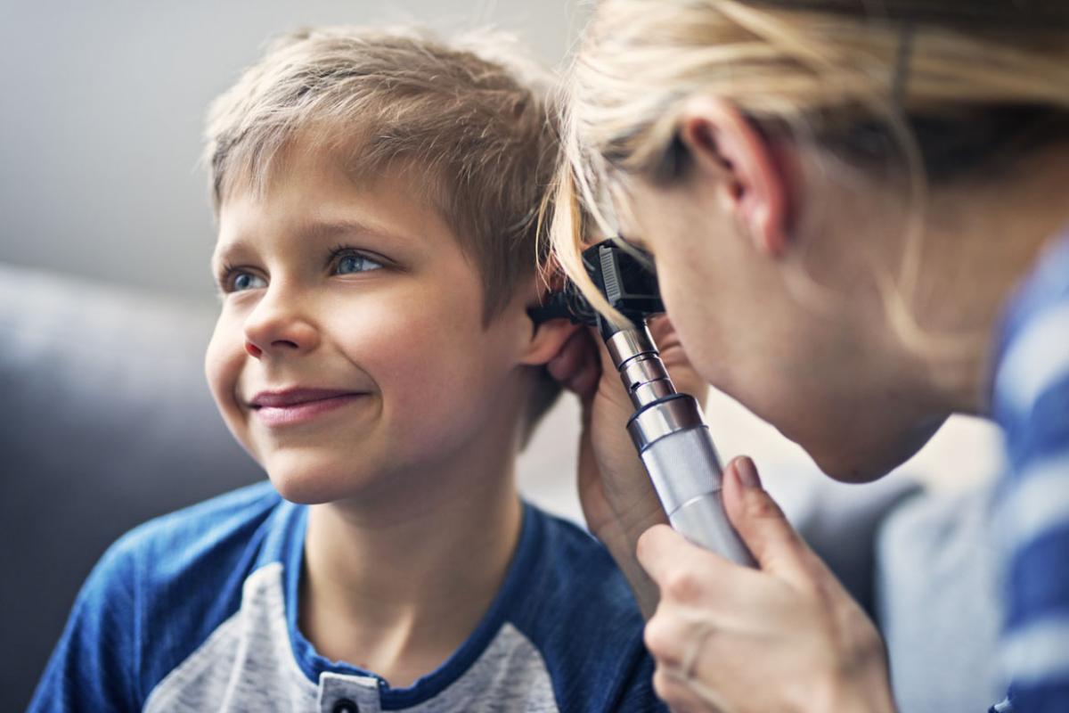 Physician examining a child patient's ear
