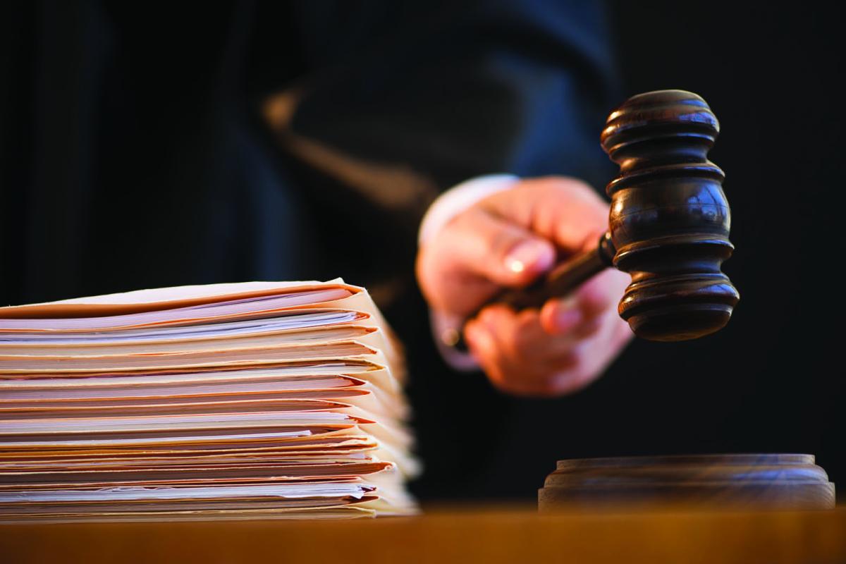 Gavel next to stack of file folders