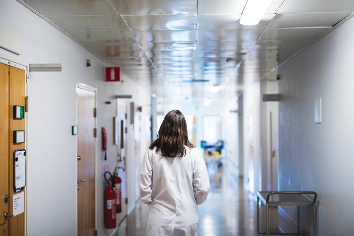 Female physician walking down hallway