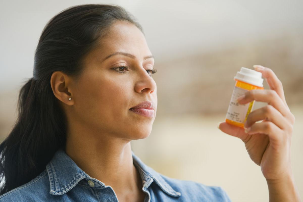 Woman reading a prescription container