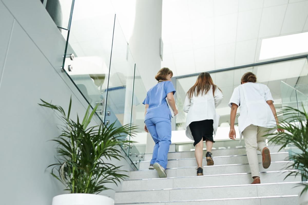 Group of physicians going up the stairs
