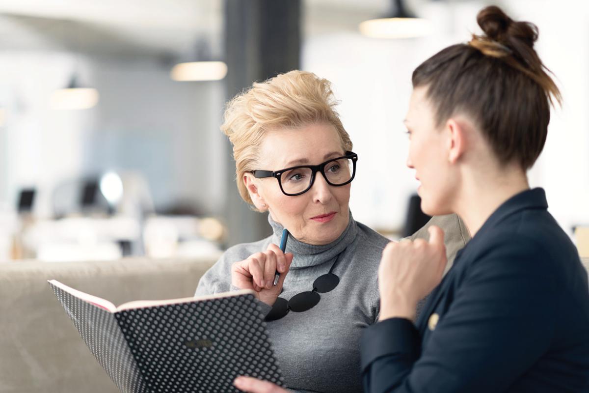 Two women speaking with one another