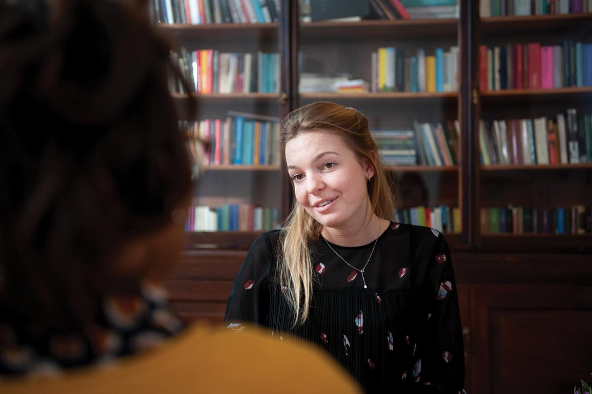 Two women speaking with one another