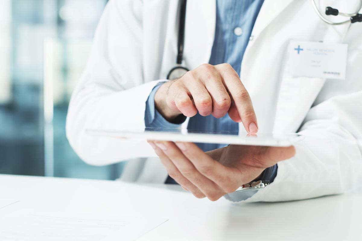 Physician scrolling on a tablet device