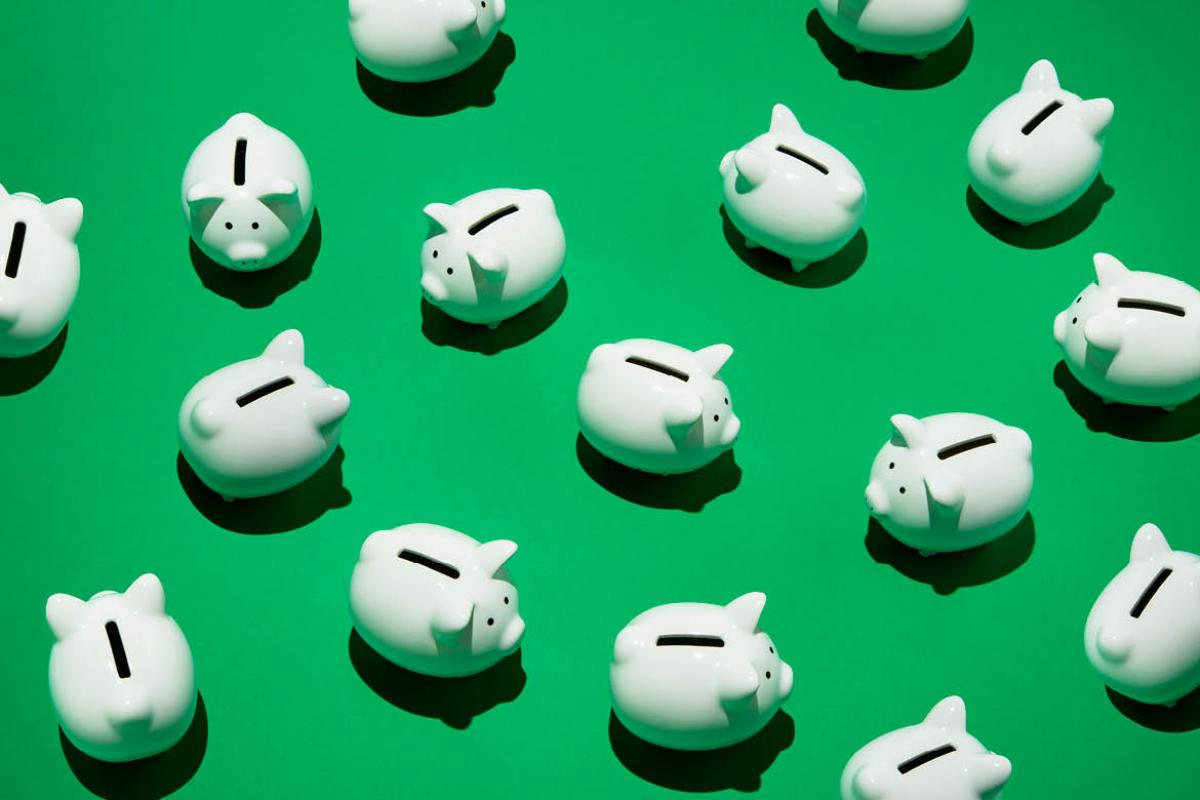 White piggy banks on a green background