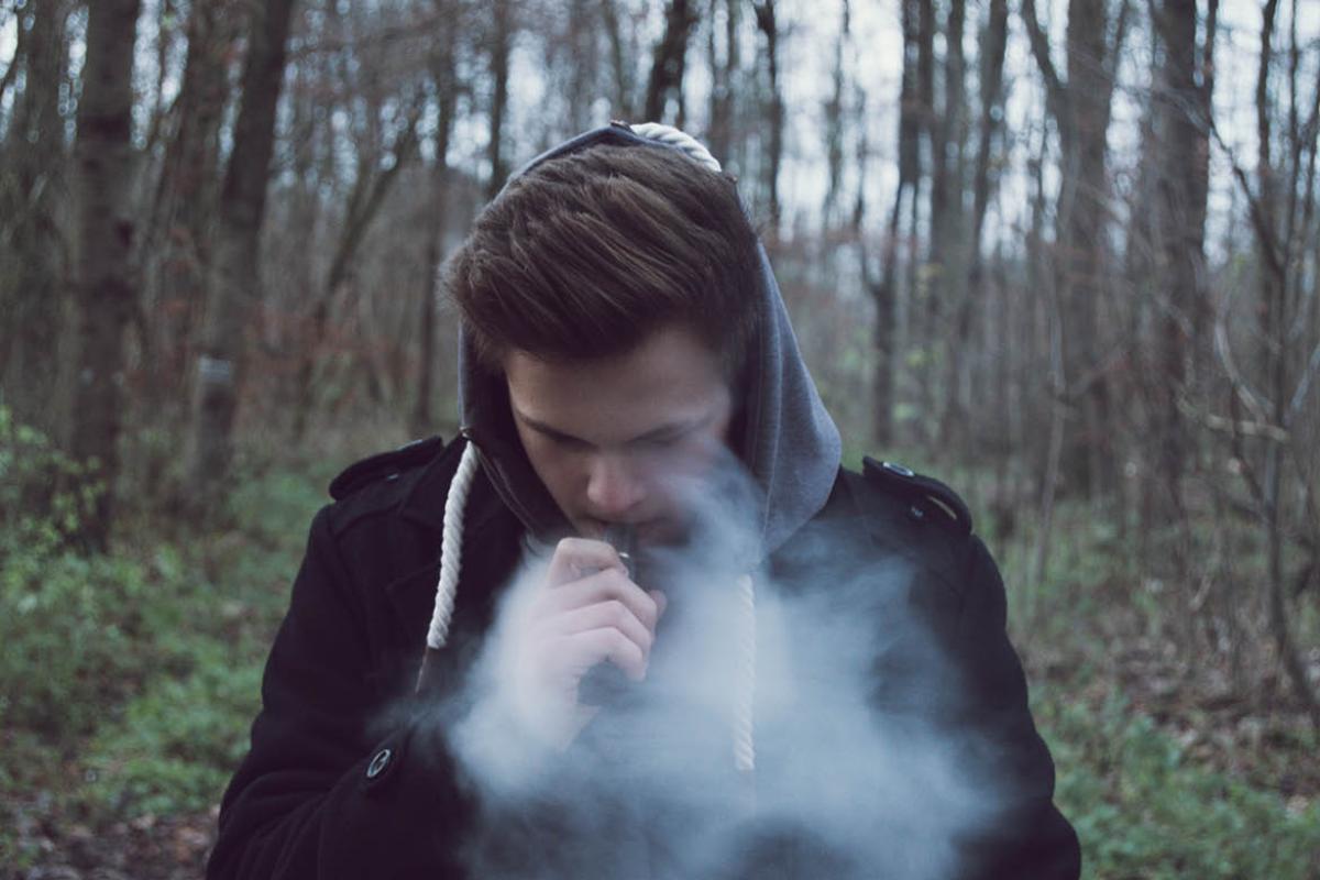Teenager smoking an e-cigarette