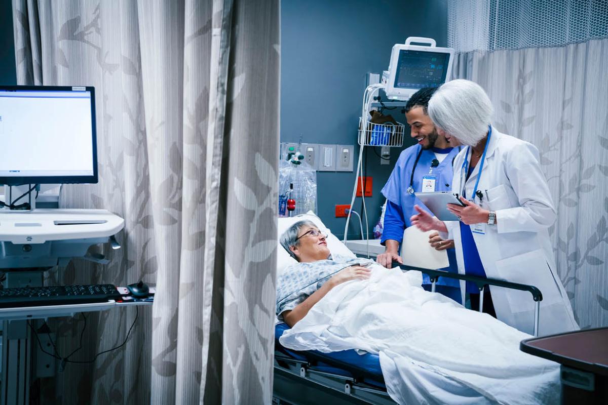 Women in emergency room, talking to her doctors