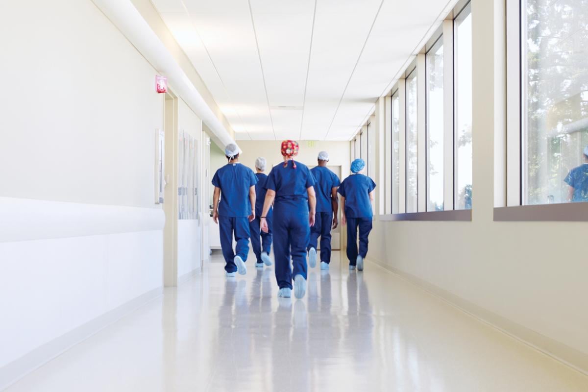 Physician team walking down a hospital hallway