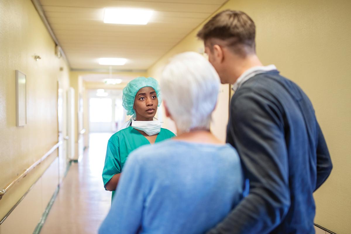 Physician talking to family in hallway