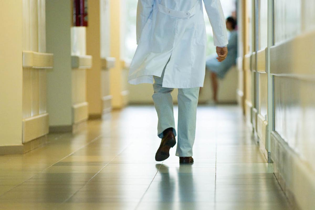Physician walking down a hallway