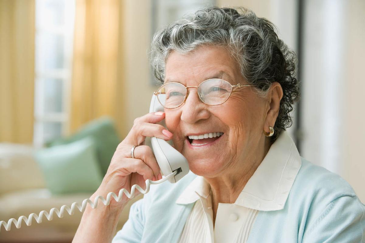 Smiling woman speaking on telephone