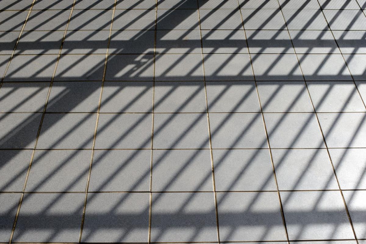 Shadows on the floor of an empty jail cell