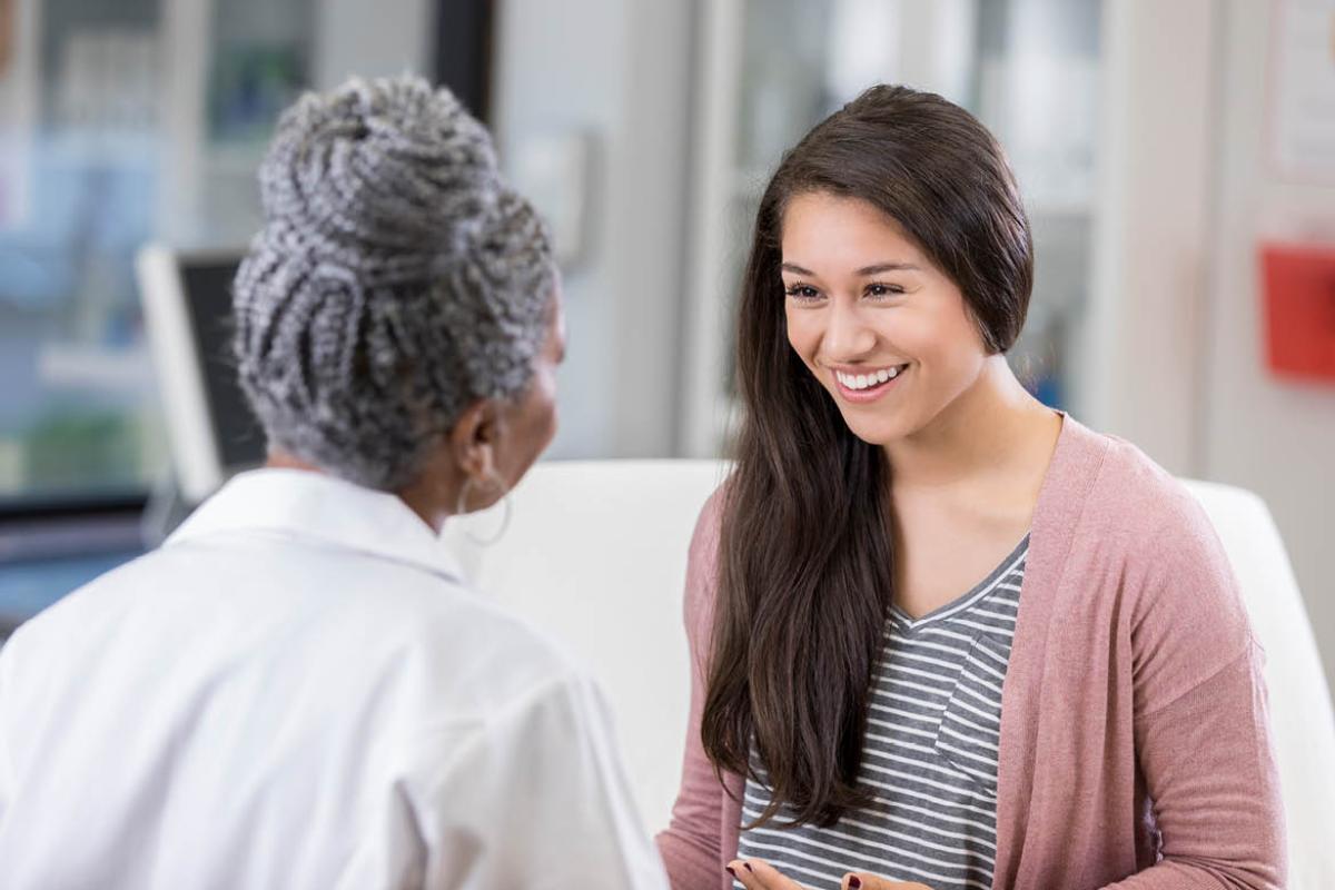 Smiling patient speaking to health care worker