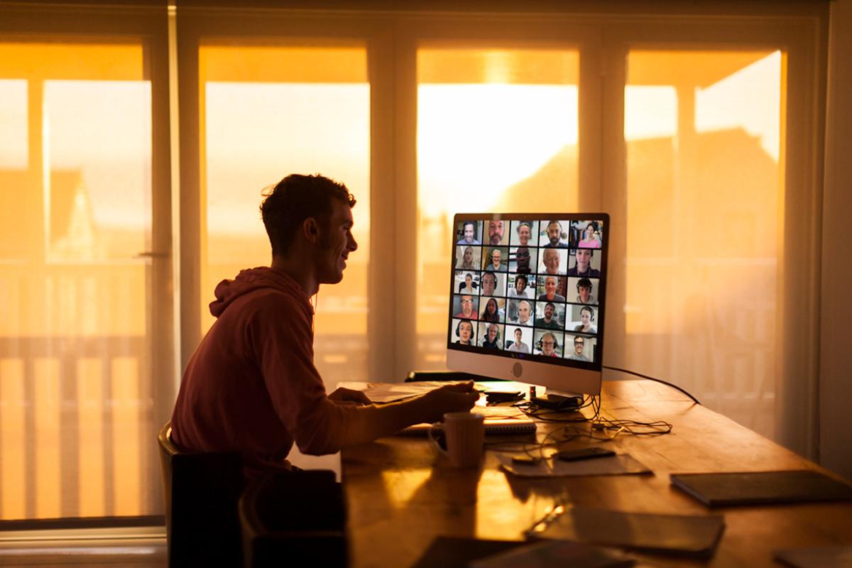 Person attending a virtual meeting on computer