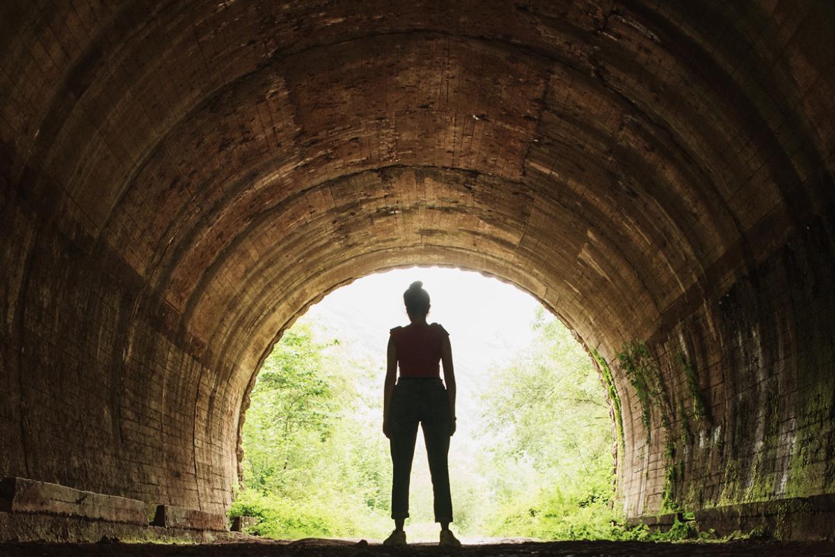 Person standing in pedestrian tunnel