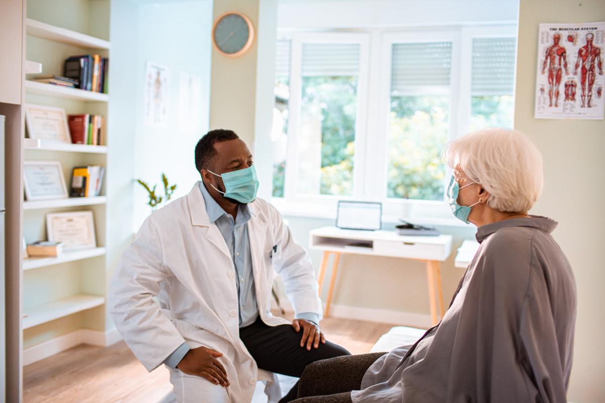 Physician and patient wearing face masks