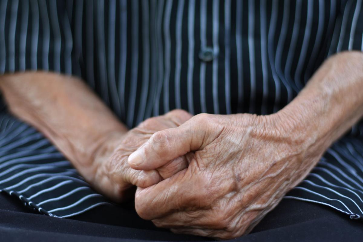 Close-up photograph of a senior's clenched hands