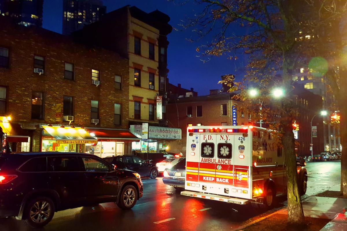 New York City street at night with an ambulance