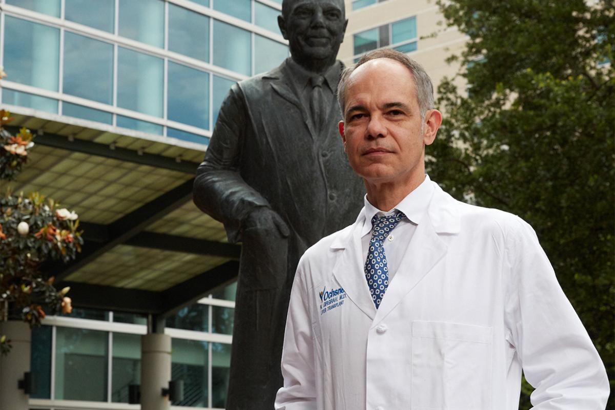Photo of Nigel Girgrah, MD, standing outside a medical center.