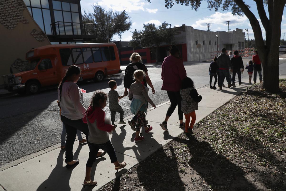 A group of parents walking with their children.