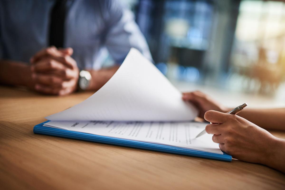 Two people sitting at desk reviewing documents
