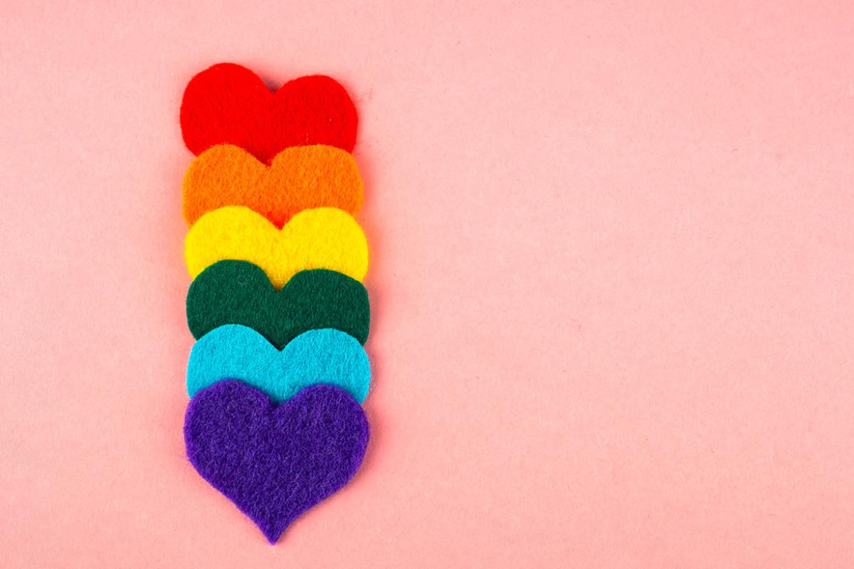 A row of felt hearts with the colors of the LGTBIQ flag