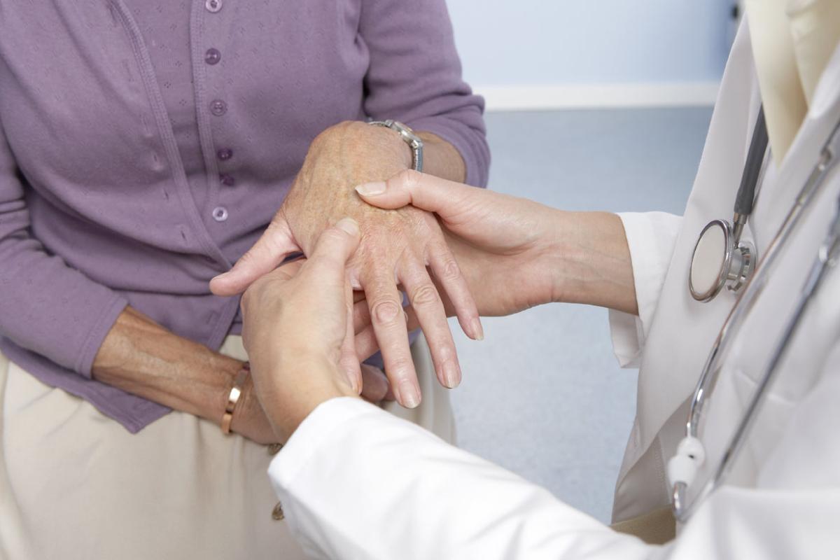 Physician examining a patient's hand