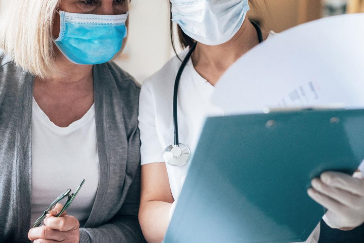 Two people looking at a clipboard