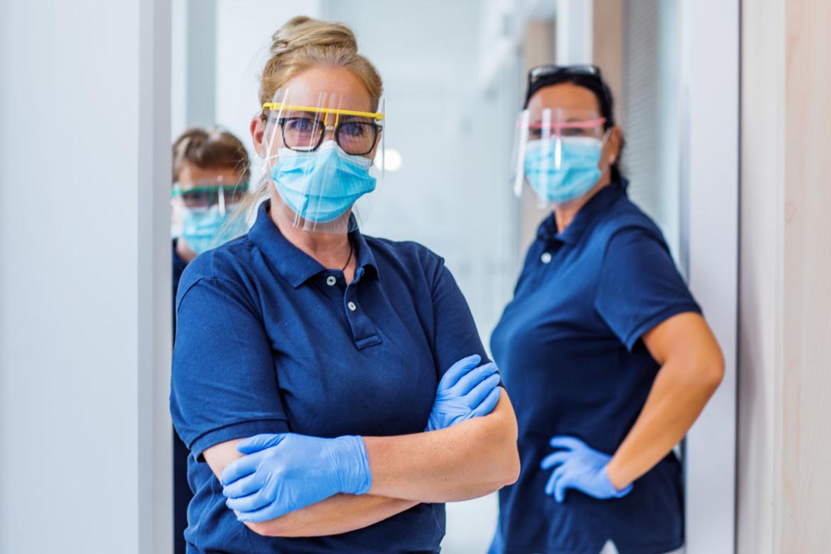 Three health care workers in PPE