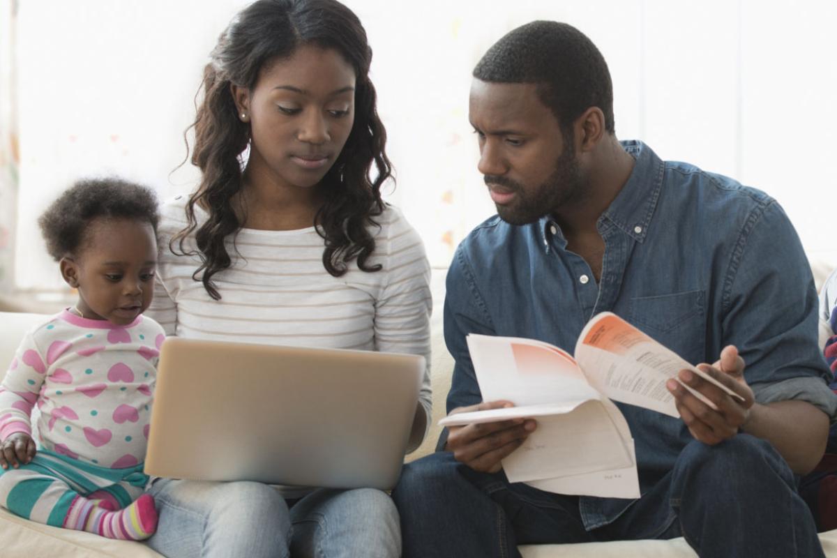 Family looking at a laptop and bills