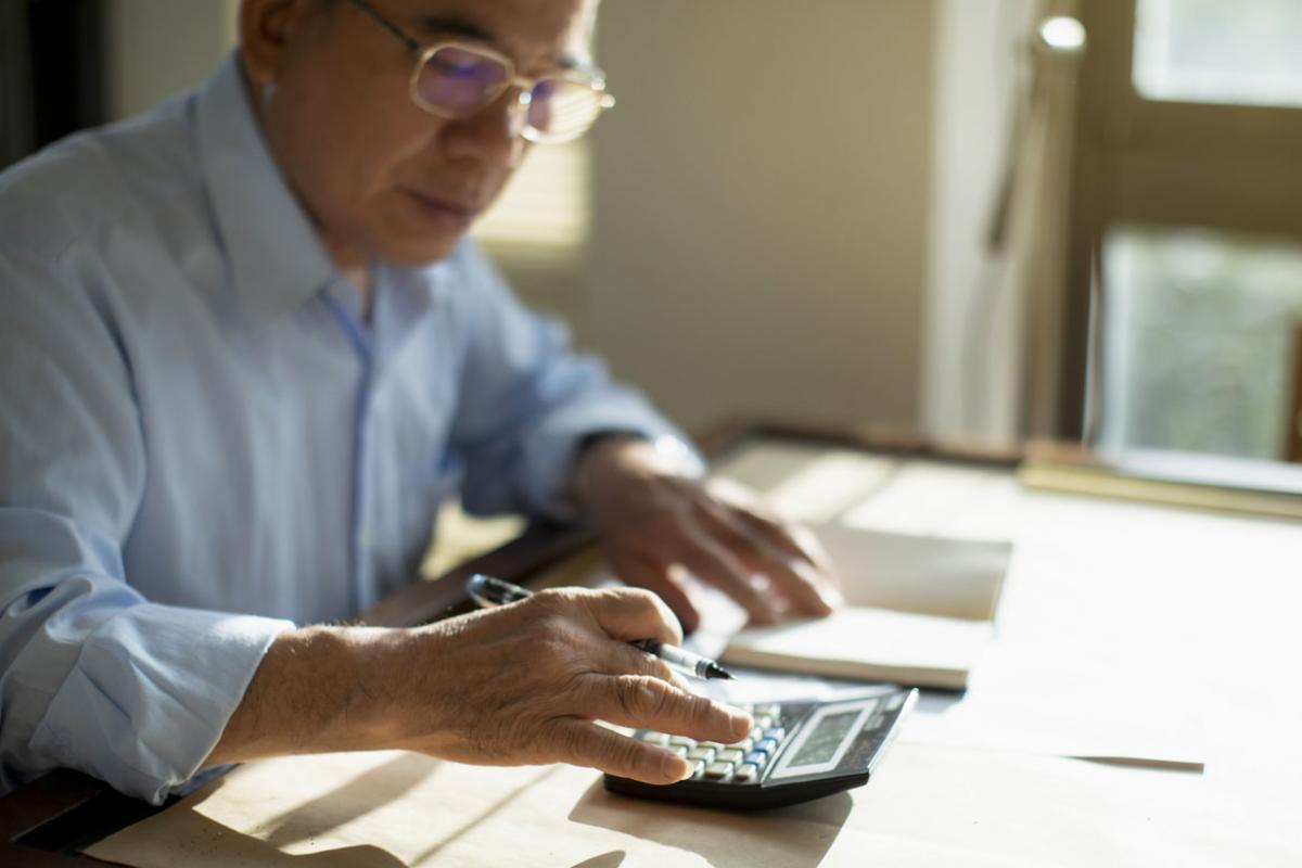 Person working on a calculator