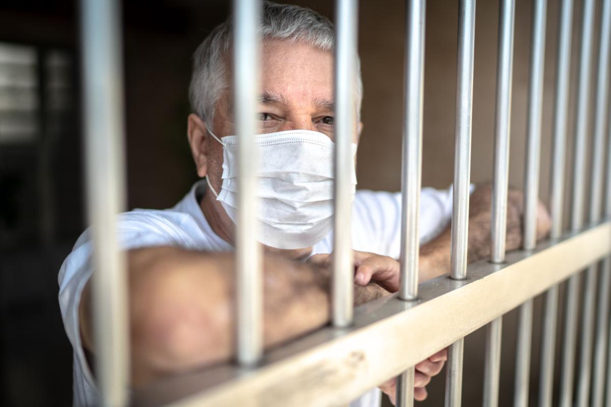 Man in a mask, in a prison cell