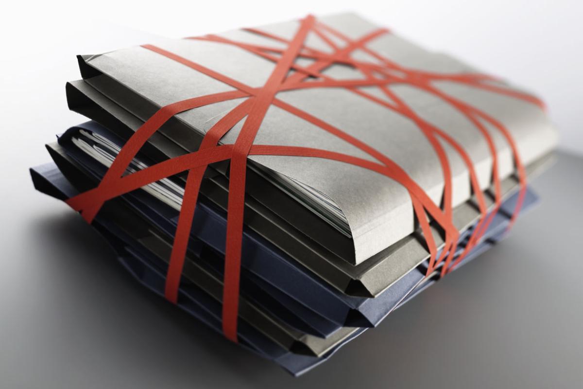 Stack of files wrapped up with red tape
