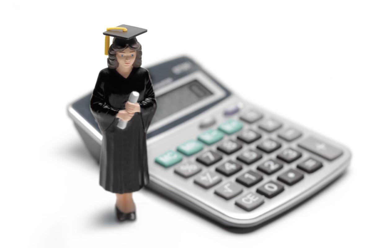 Figure in cap and gown next to a calculator