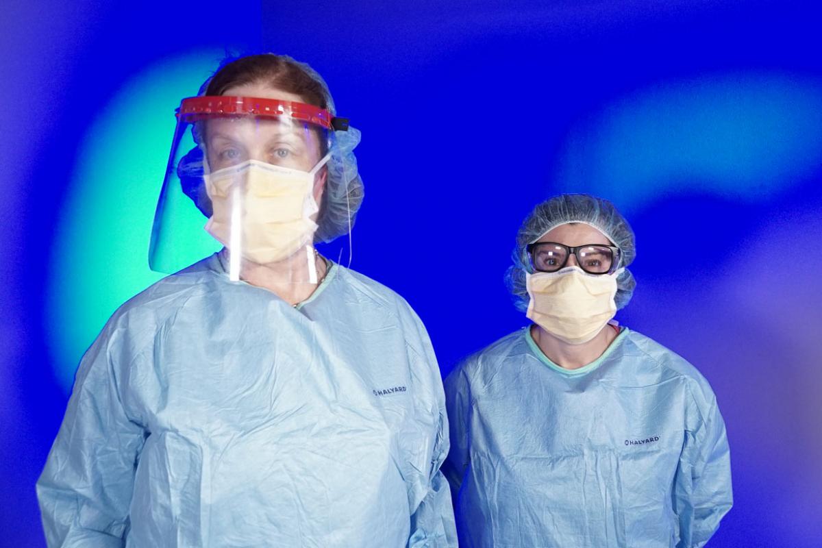 Two female physicians in ill-fitting PPE gear