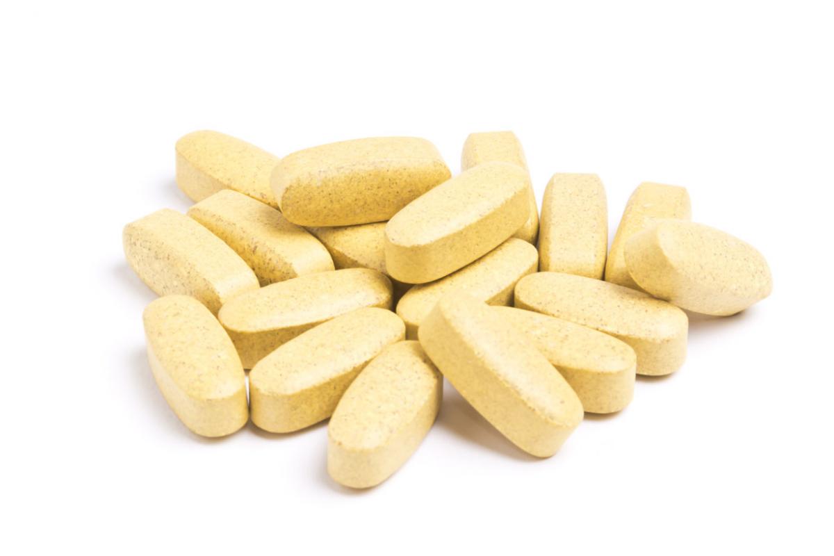 A pile of vitamins on a white background.