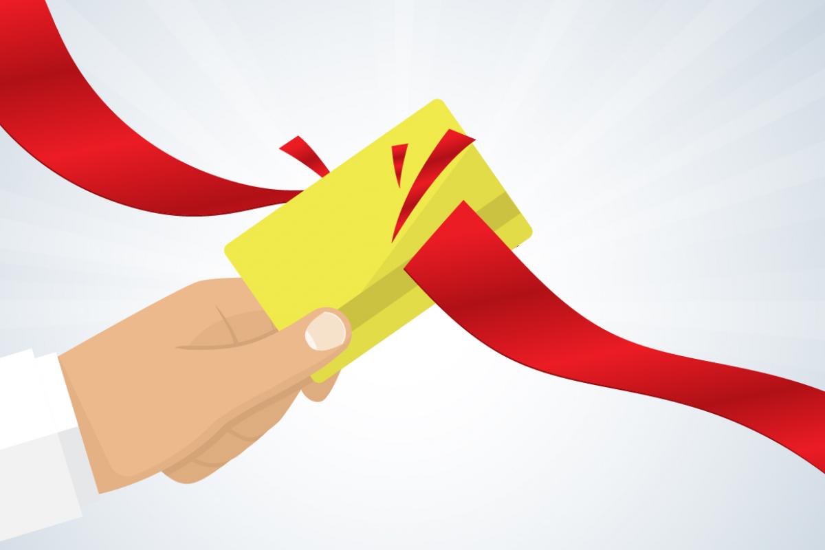 Illustration of a gold card with a red ribbon or tape slicing through it.
