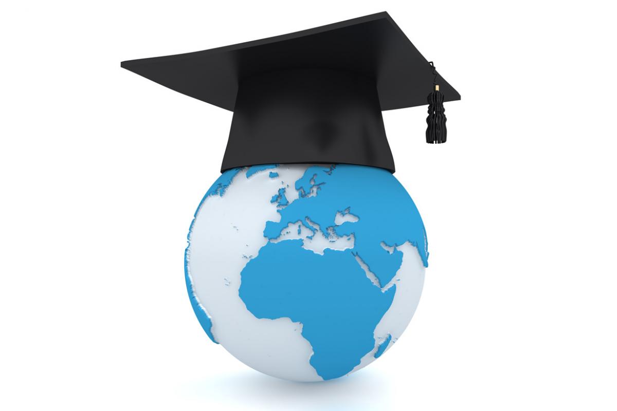 A globe of the world with a graduation cap placed on top