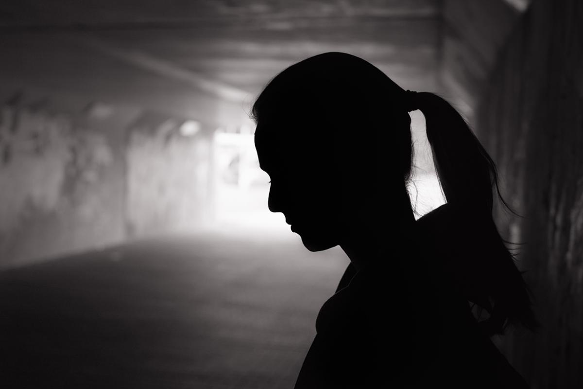 Silhouette of a person in a street tunnel