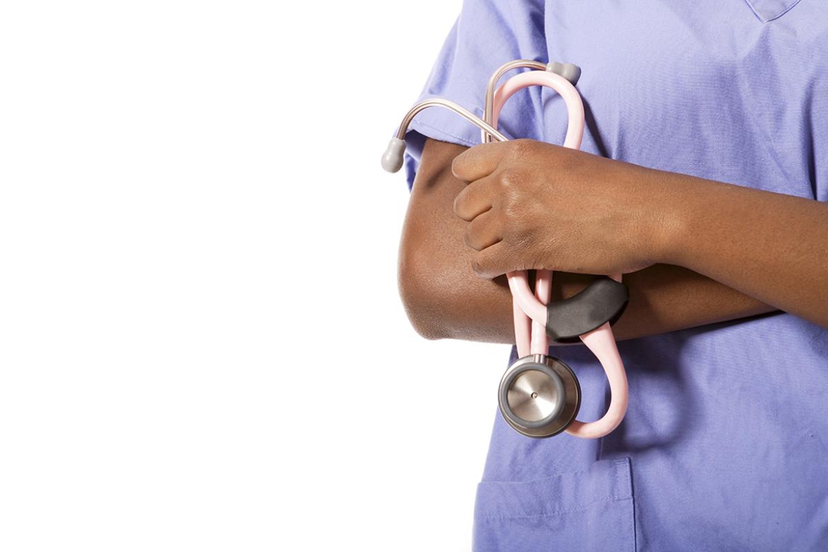 Health care worker holding stethoscope