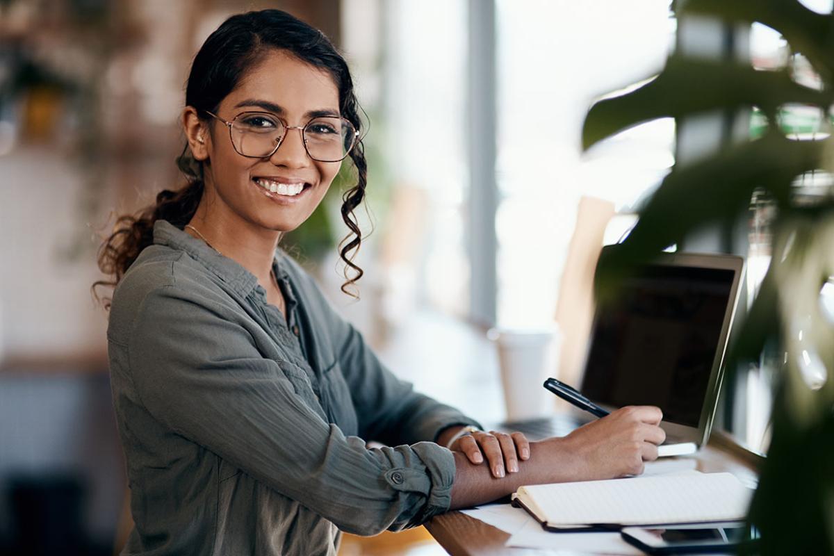 Smiling person working at a desk