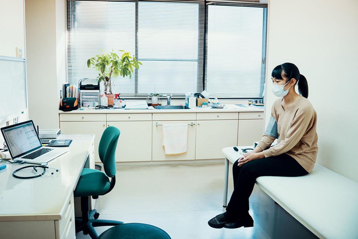 Patient sitting in empty examination room