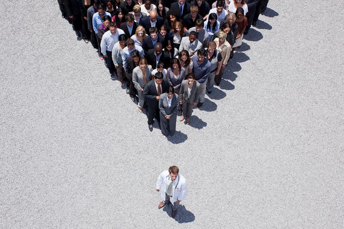 Group of people shaped in a triangle