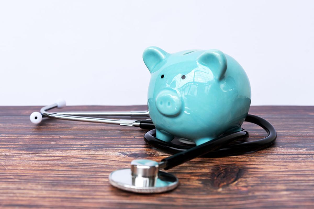 Piggy bank encircled by a stethoscope