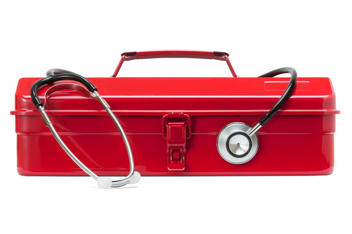 Stethoscope draping a red toolkit
